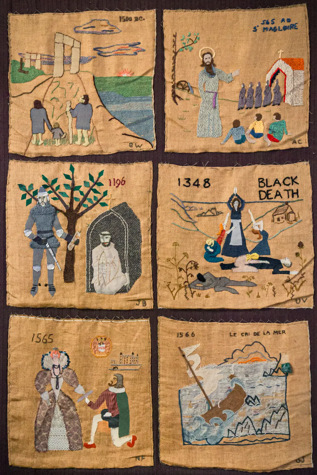 A collection of six embroidered panels depicting historical events from 1500 BC to 1566, including scenes of the Black Death and local figures.