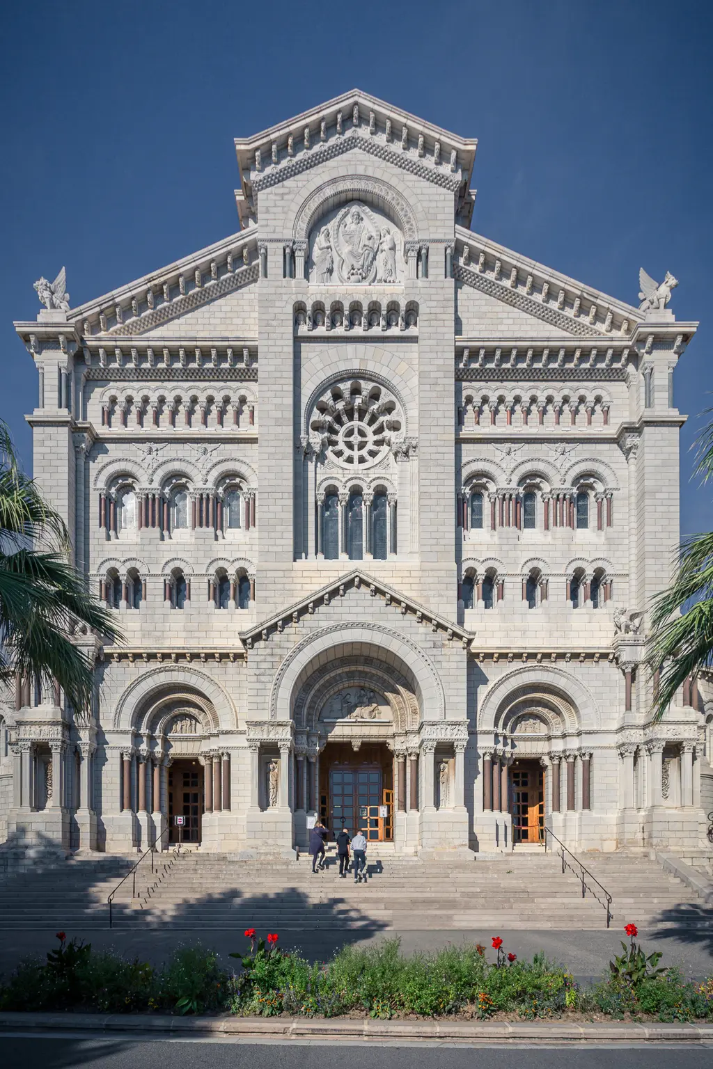 Cathedral of Notre-Dame-Immaculée in Monaco: An impressive stone façade with intricate architectural details and steps.