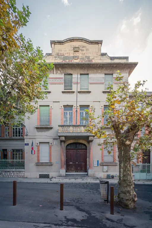 Historic Ecole élémentaire Louis Marin in La Ciotat, featuring classic architectural details and surrounding trees.