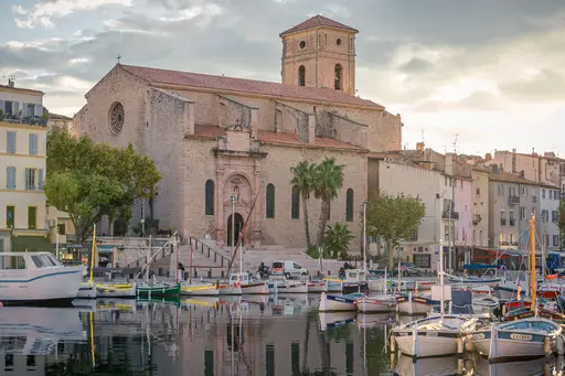 Église Notre-Dame-de-l'Assomption in La Ciotat, with boats in the harbor and picturesque buildings along the waterfront.